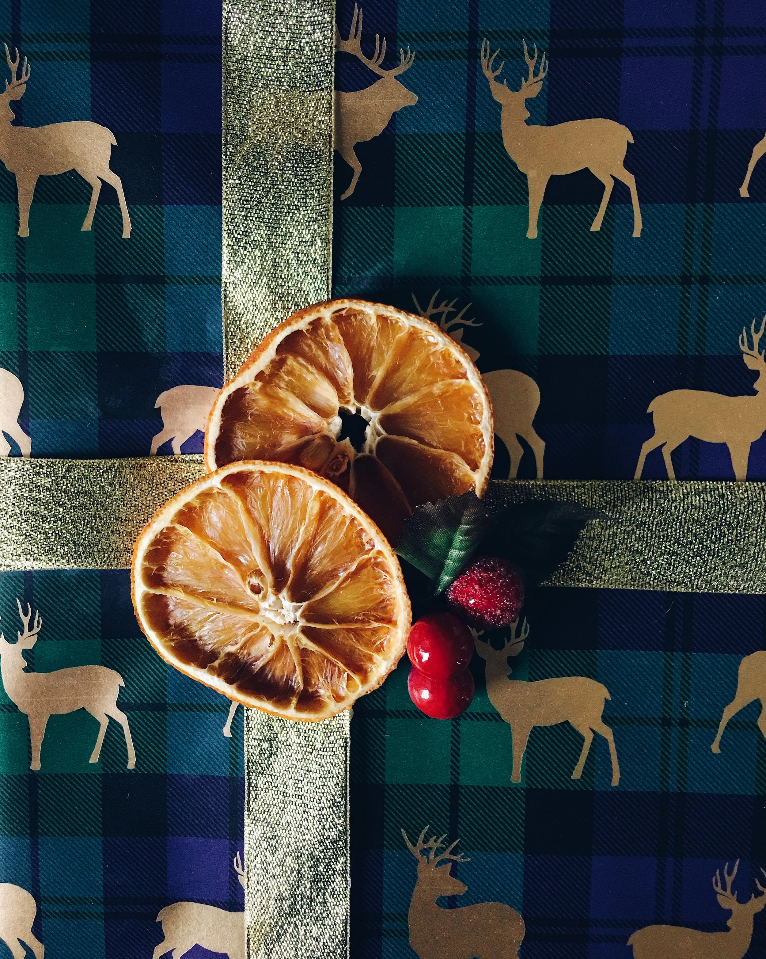 This tartan deer wrapping paper is by M&S. The gold ribbon and faux berries are by Hobbycraft.