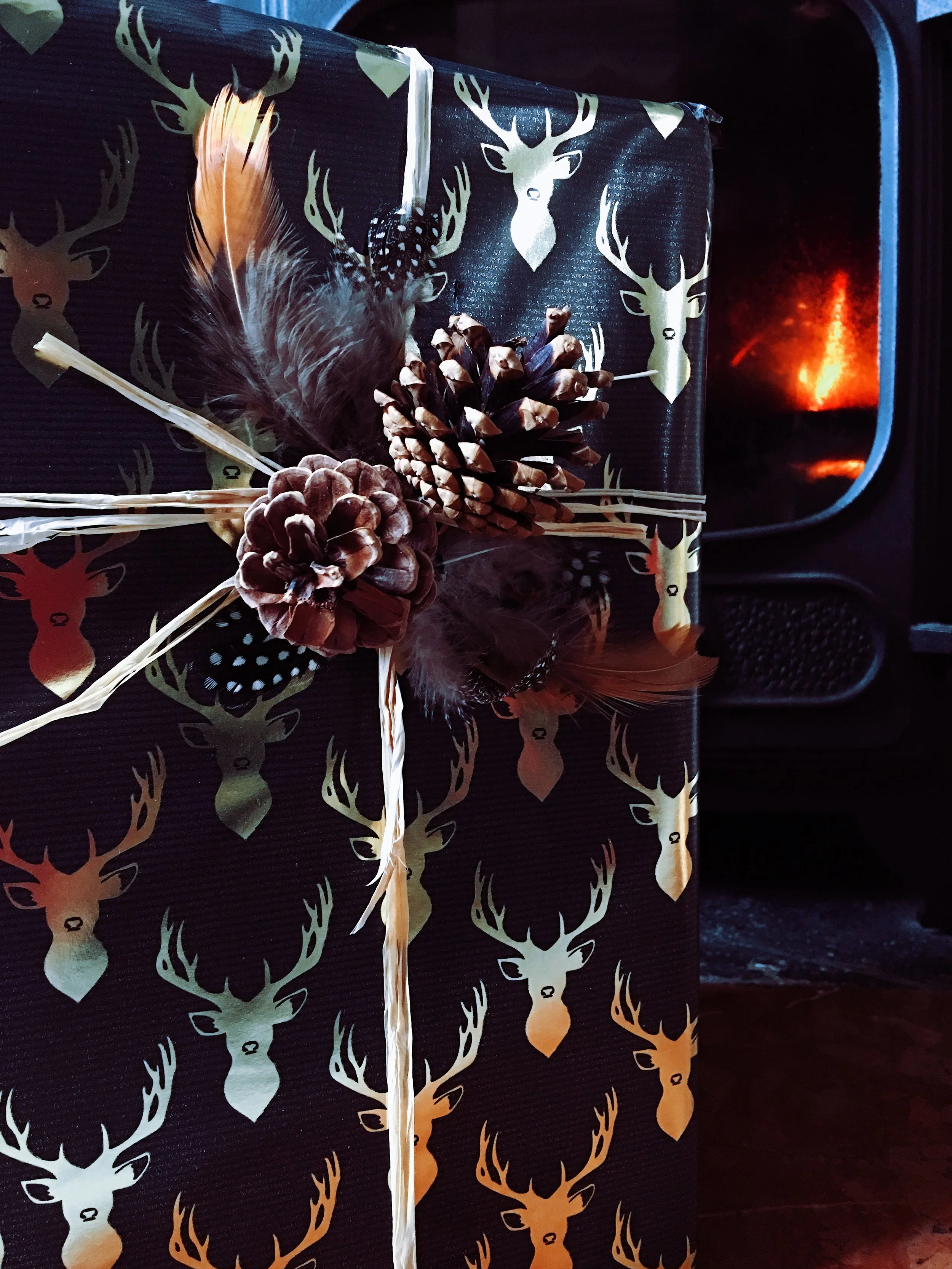 Black and gold wrapping paper by Sainsbury's. Raffia and feathers from Hobbycraft. Fir cones collected from Epping forest!