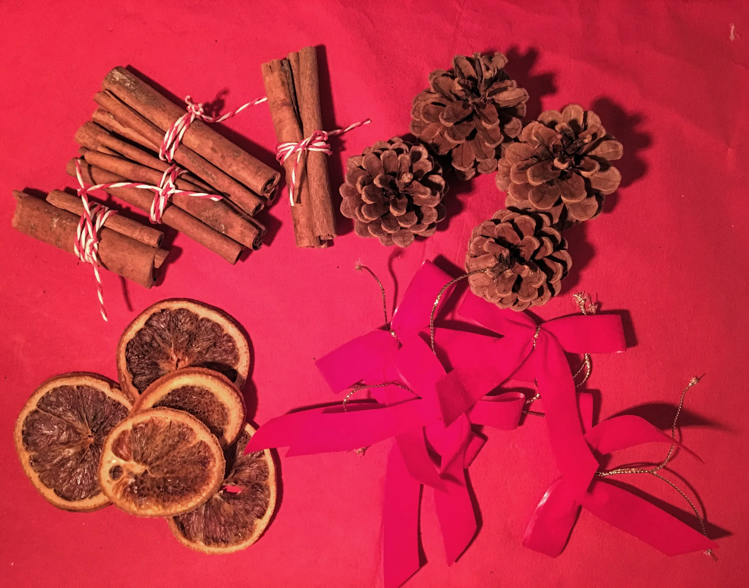 Along with your dehydrated orange slices and cinnamon sticks, use fir cones and red velvet bows.