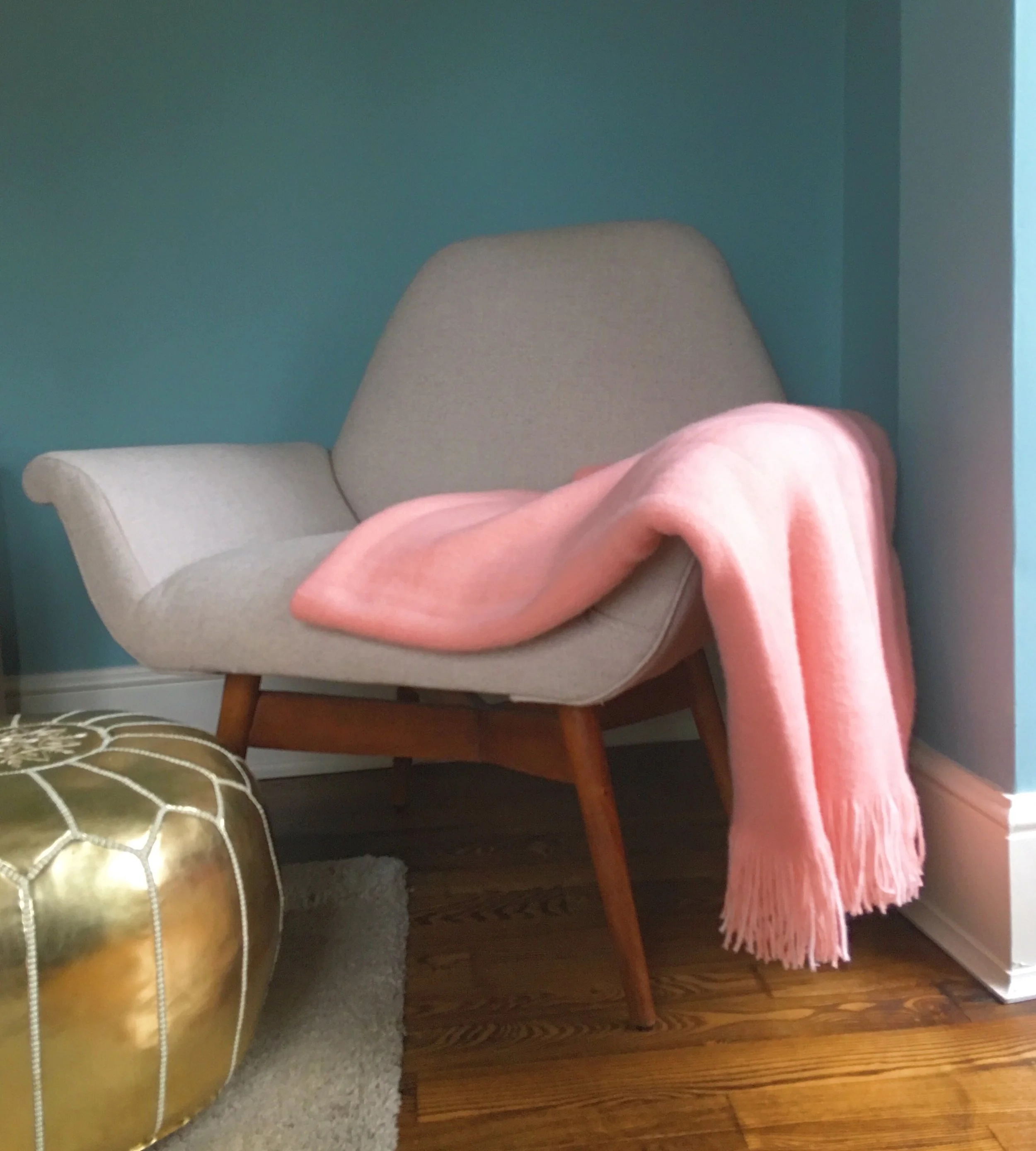 My pink throw at home complements my blue walls in my living room.