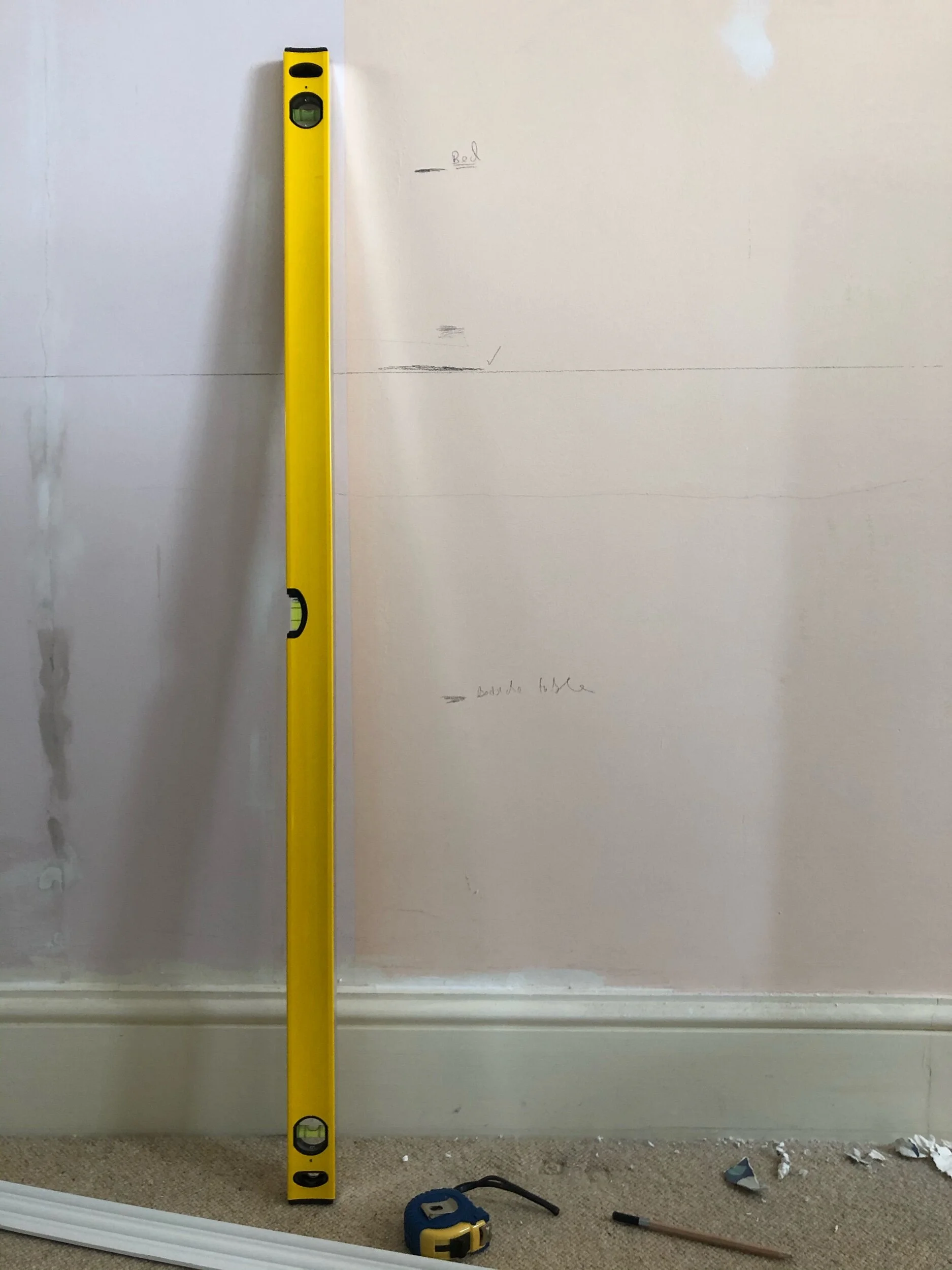 I marked the height level of existing furniture in the room and then pencilled on the perfect position for the central dado chair rail.