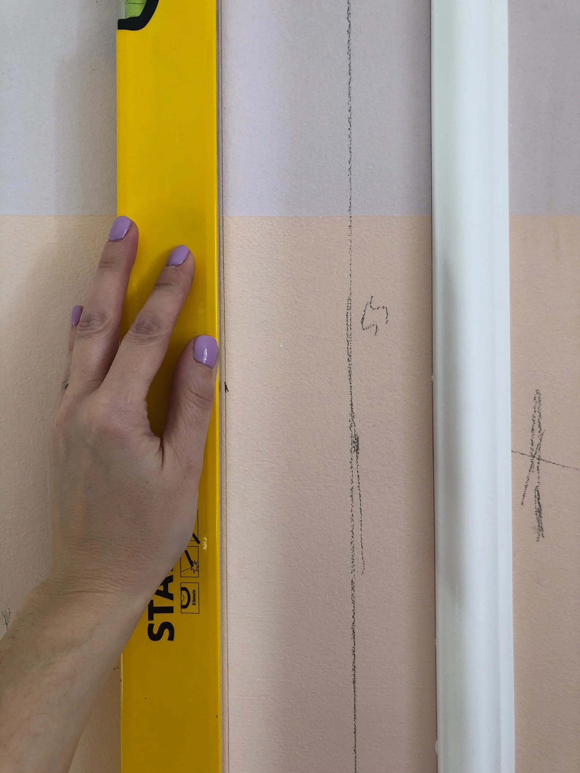 Always double check your measurements and use your spirit level continuously to check the placement of each panel piece. Each piece is a domino for the placement of the next panel, so it is important to get it right!