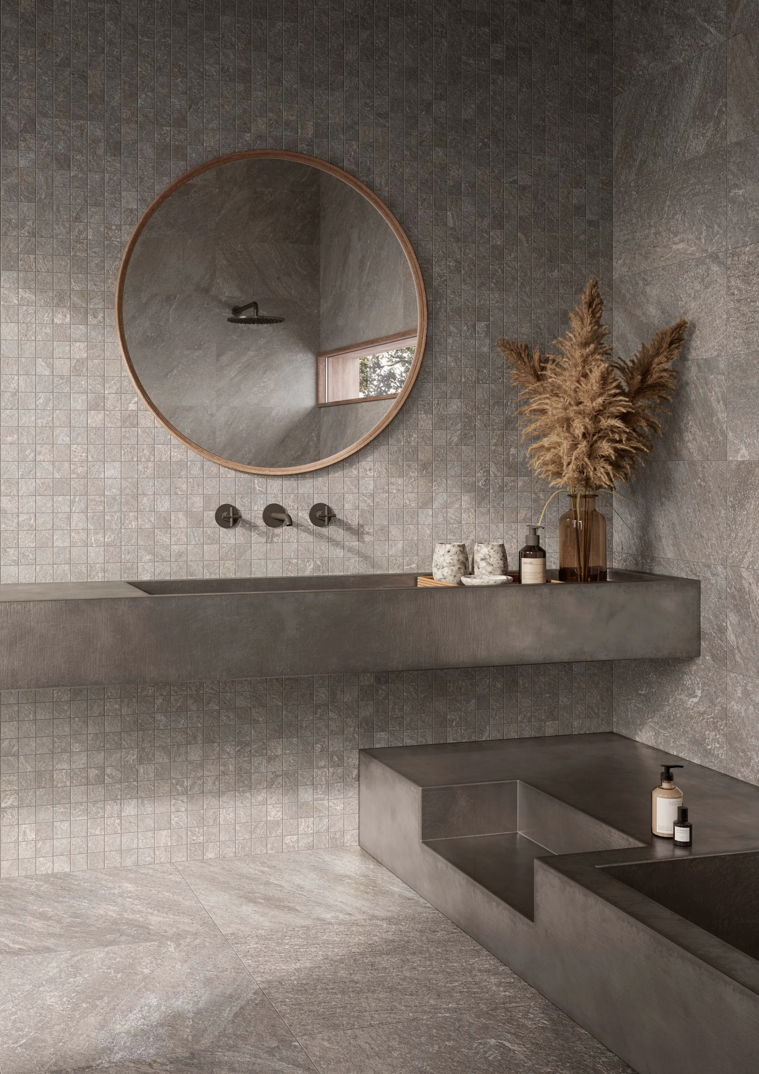 Petra Antracite in the options of mosaic, squared and rectangled creates an urban look which is combined with wild grasses and a wood-trim mirror to warm up the space.