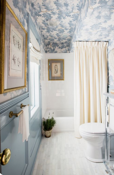 En suites and small bathrooms are a great place to be bold with your decor choices, like this wallpapered ceiling as part of a scheme designed by Shaun Smith