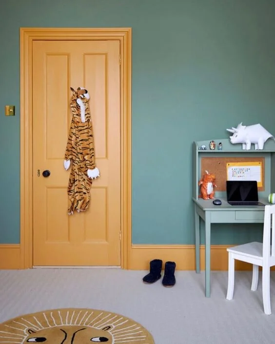 Using a vibrant colour only on the woodwork only makes this an enjoyable, fun room, without the colour being overbearing. Bedroom design by Fiona Duke Interiors.