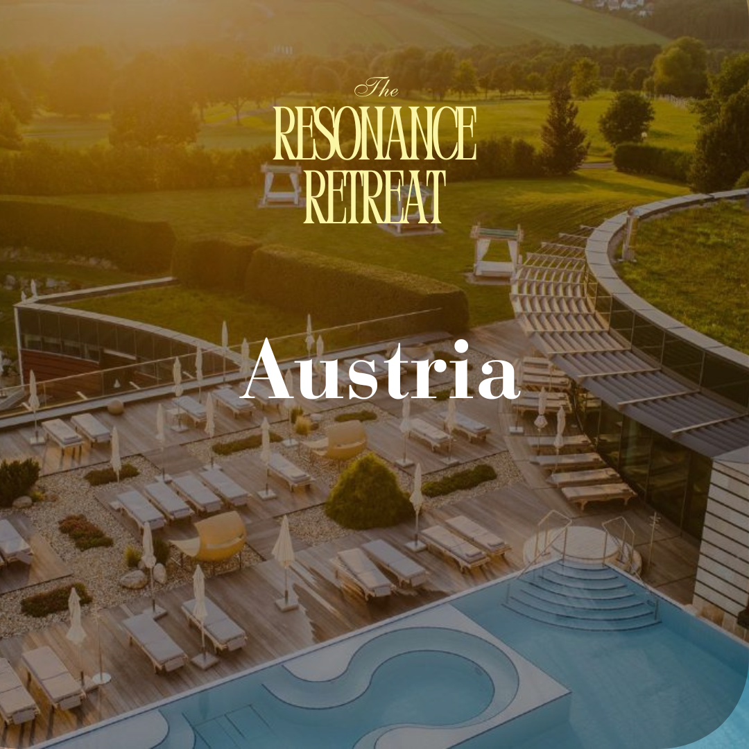 A luxurious outdoor pool area with sun loungers and umbrellas, overlooking a lush, green landscape in Austria.