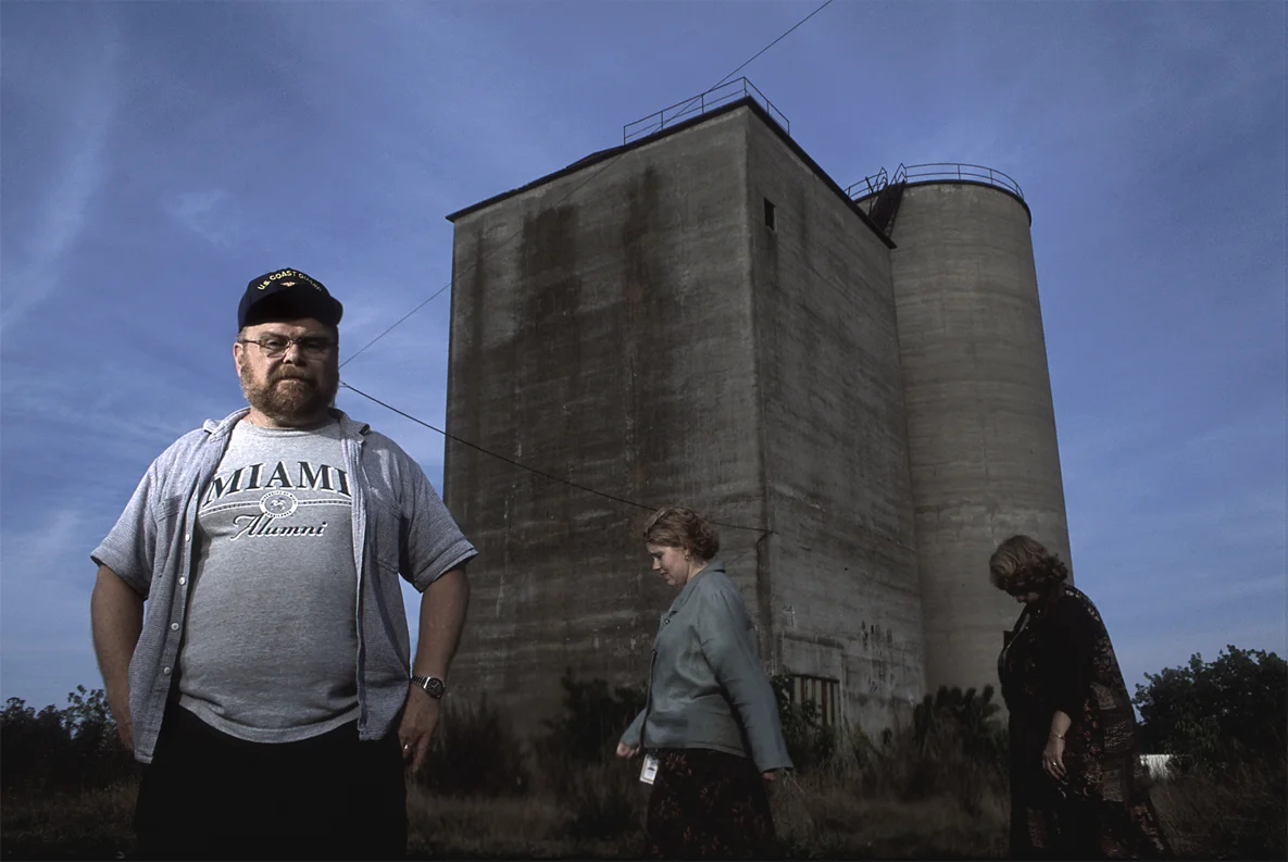 Man next to cement towers.jpg