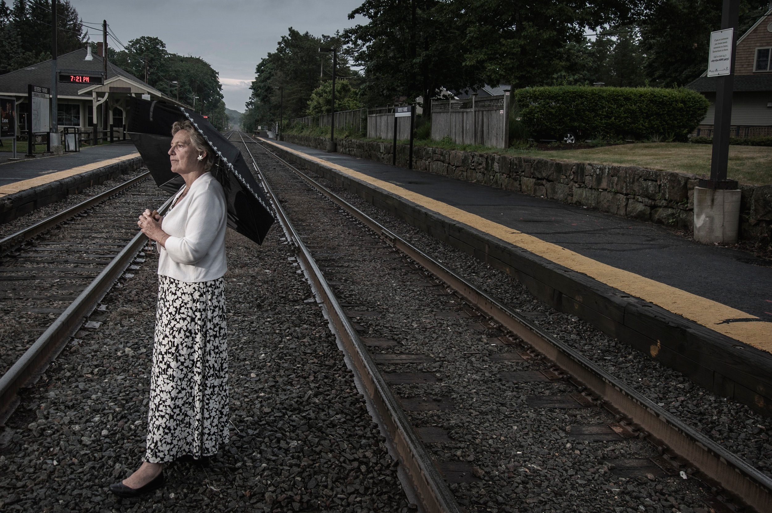 woman w umbrella bev farms station.jpg