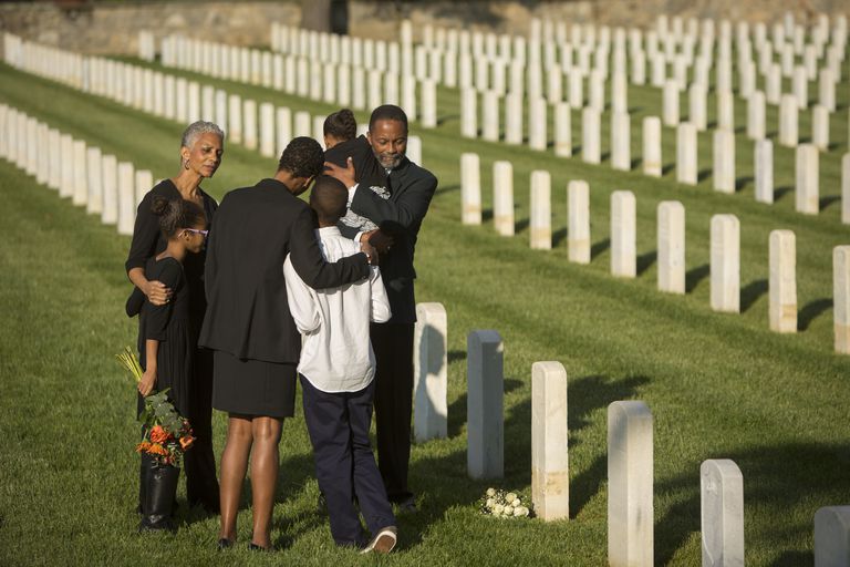 multi-generation-black-family-hugging-in-military-cemetery-672154195-59595ea33df78c4eb63ddff5.jpg