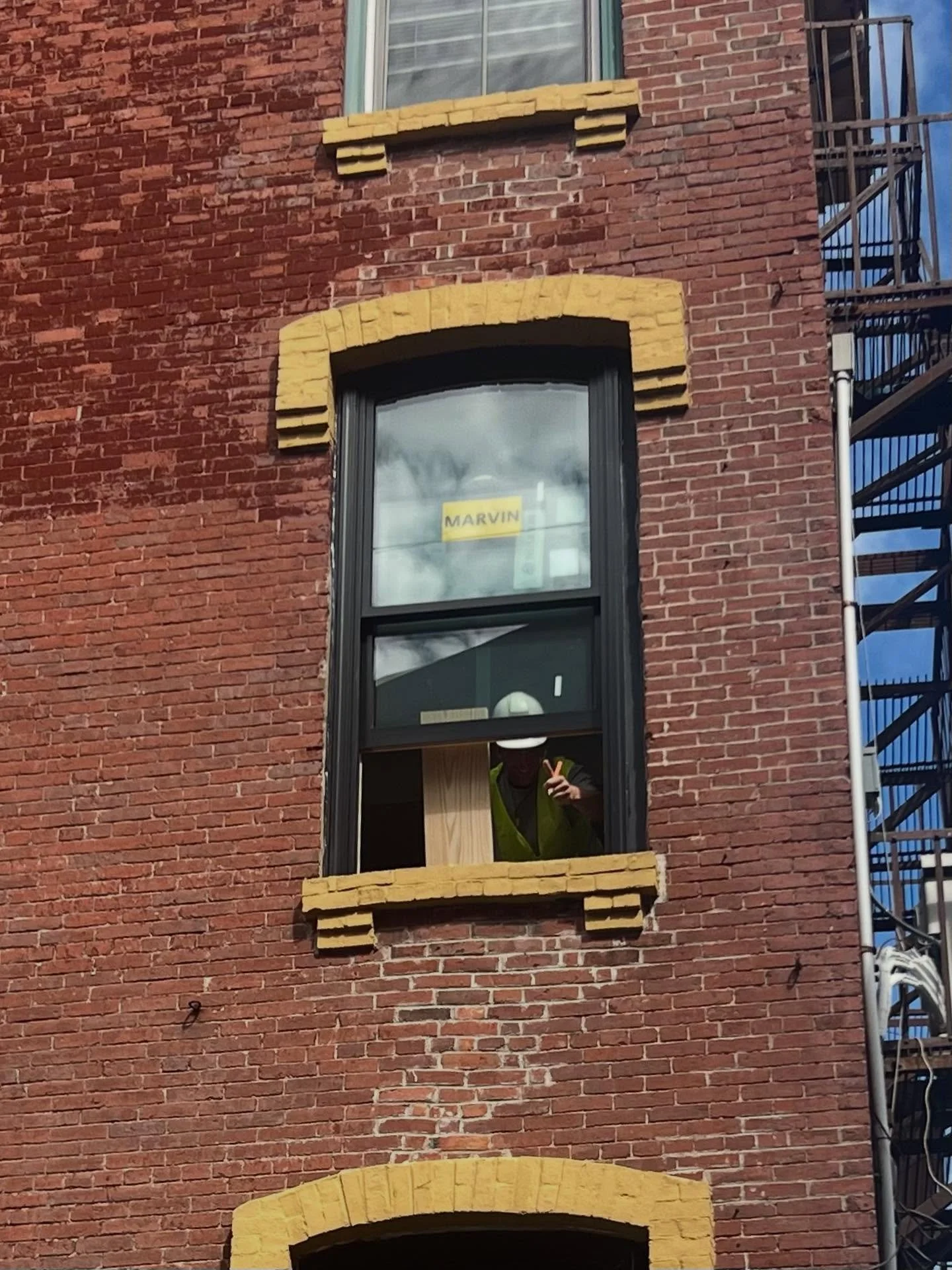 Beautiful black, arched-top Marvin windows going in! 👍 @themarvinbrand