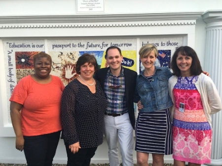 Michael J. Ferreira and Barnstable Public School employees celebrating the unveiling of "Pieces of Our Past"