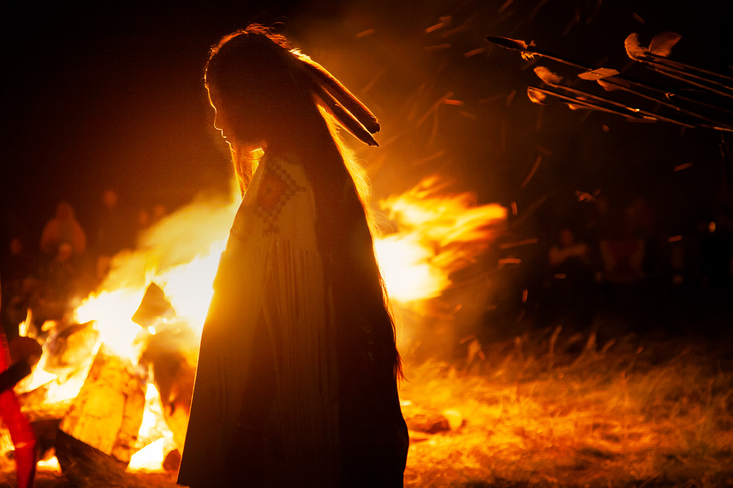 Malia Enjady, silhouetted by the campfire