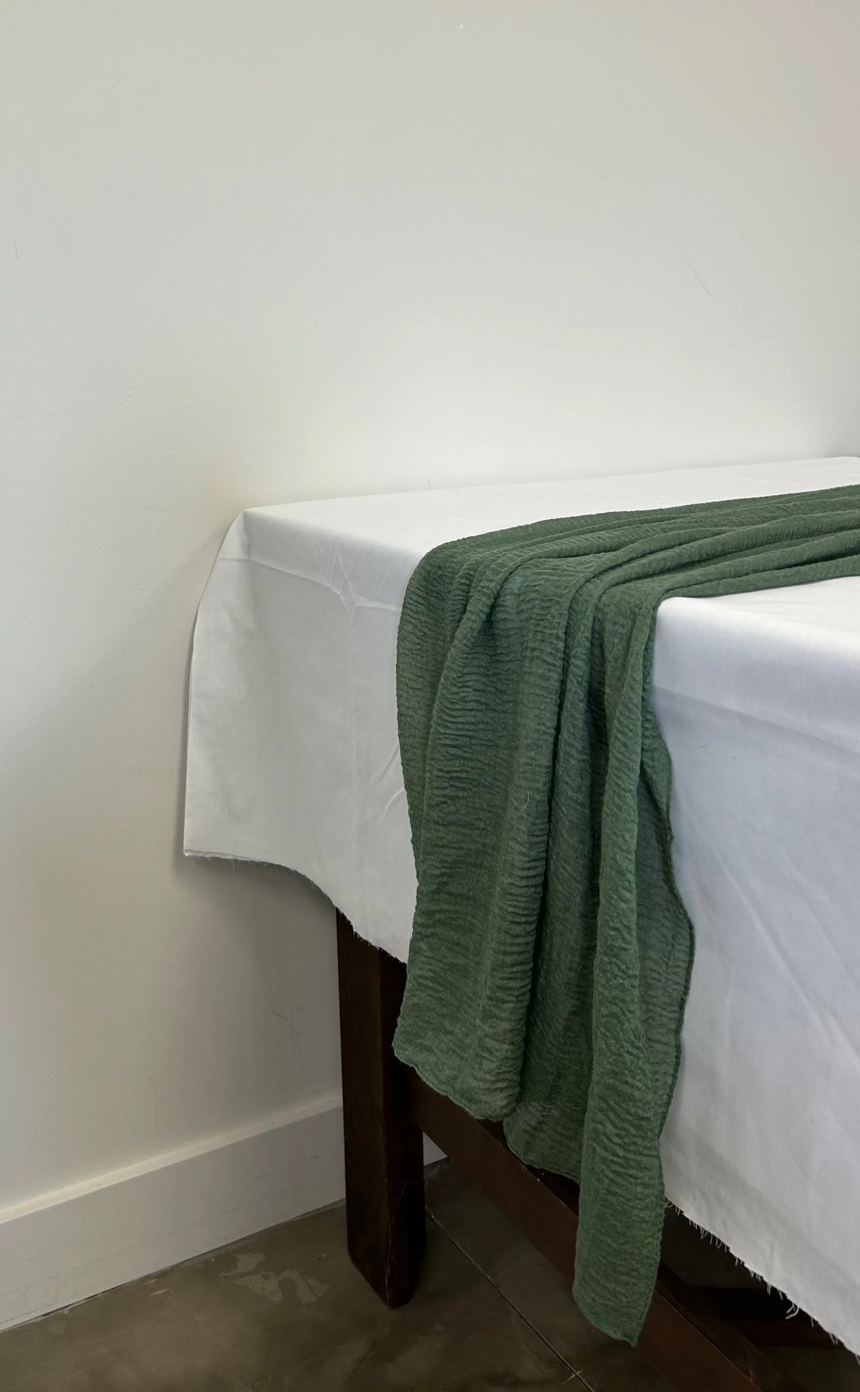 Sheer sage green table runner on white table cloth to tie together your dream colour scheme