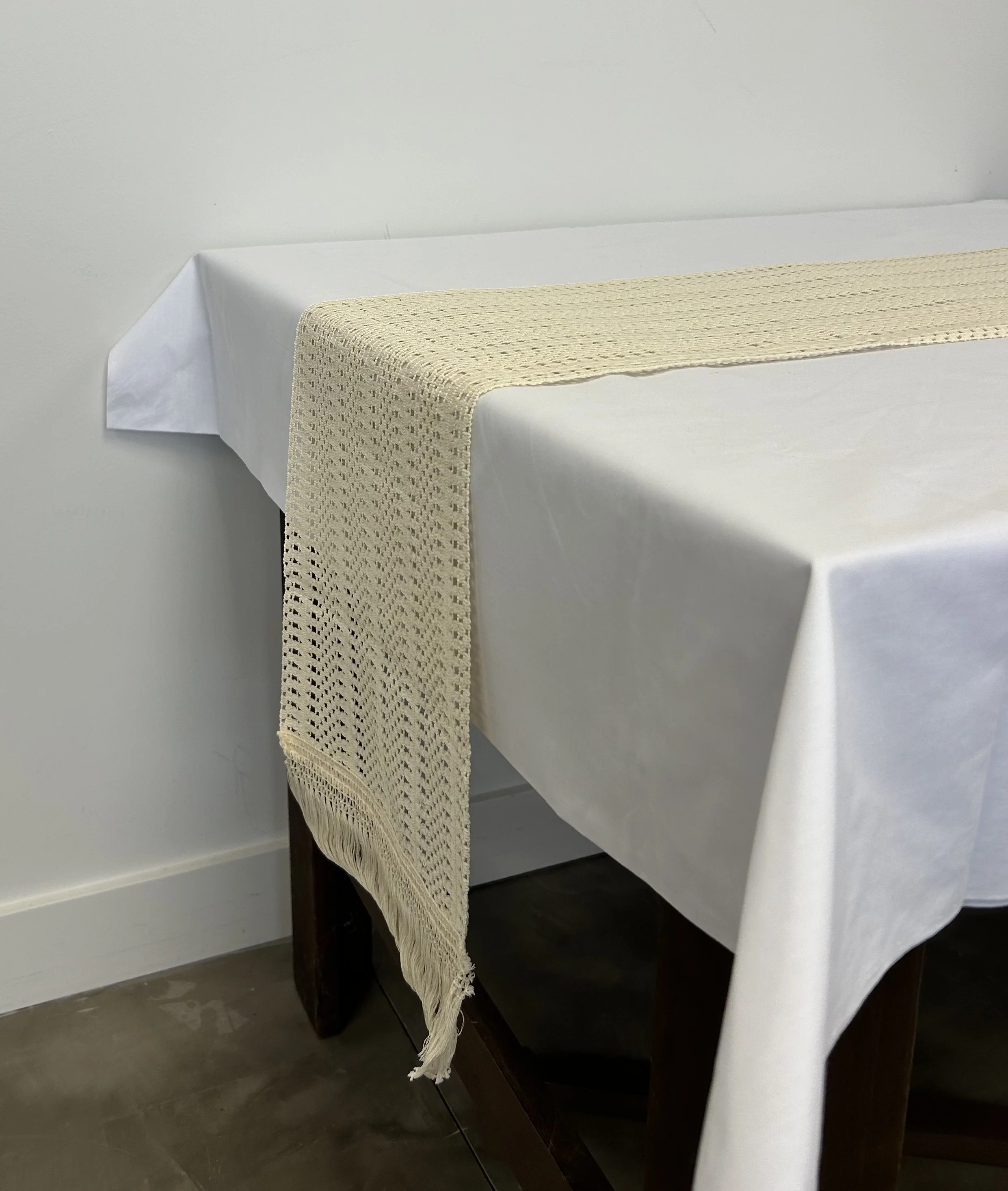Bring the vintage feel with this tan macrame table runner