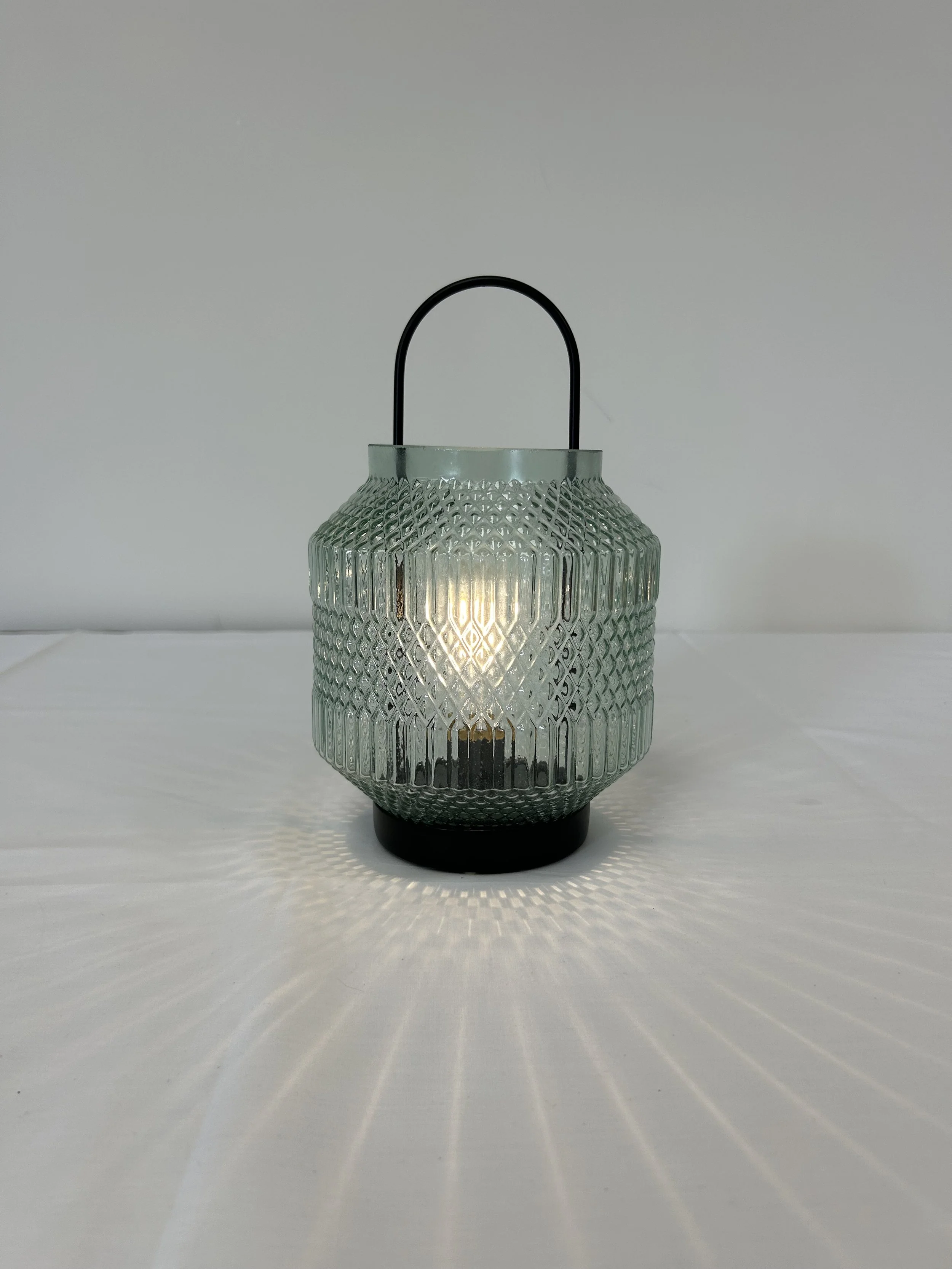 Glass lantern with black fixtures to bring some light to your event space