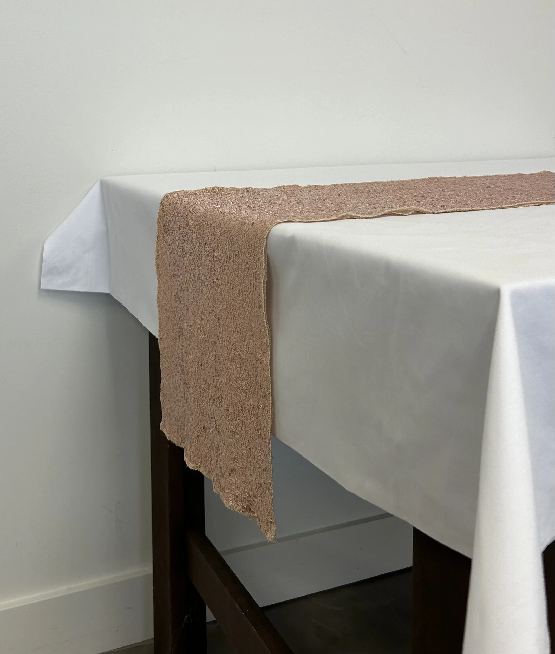 Rose gold sequin table runner on white table cloth to add some glitz to your table's centrepiece