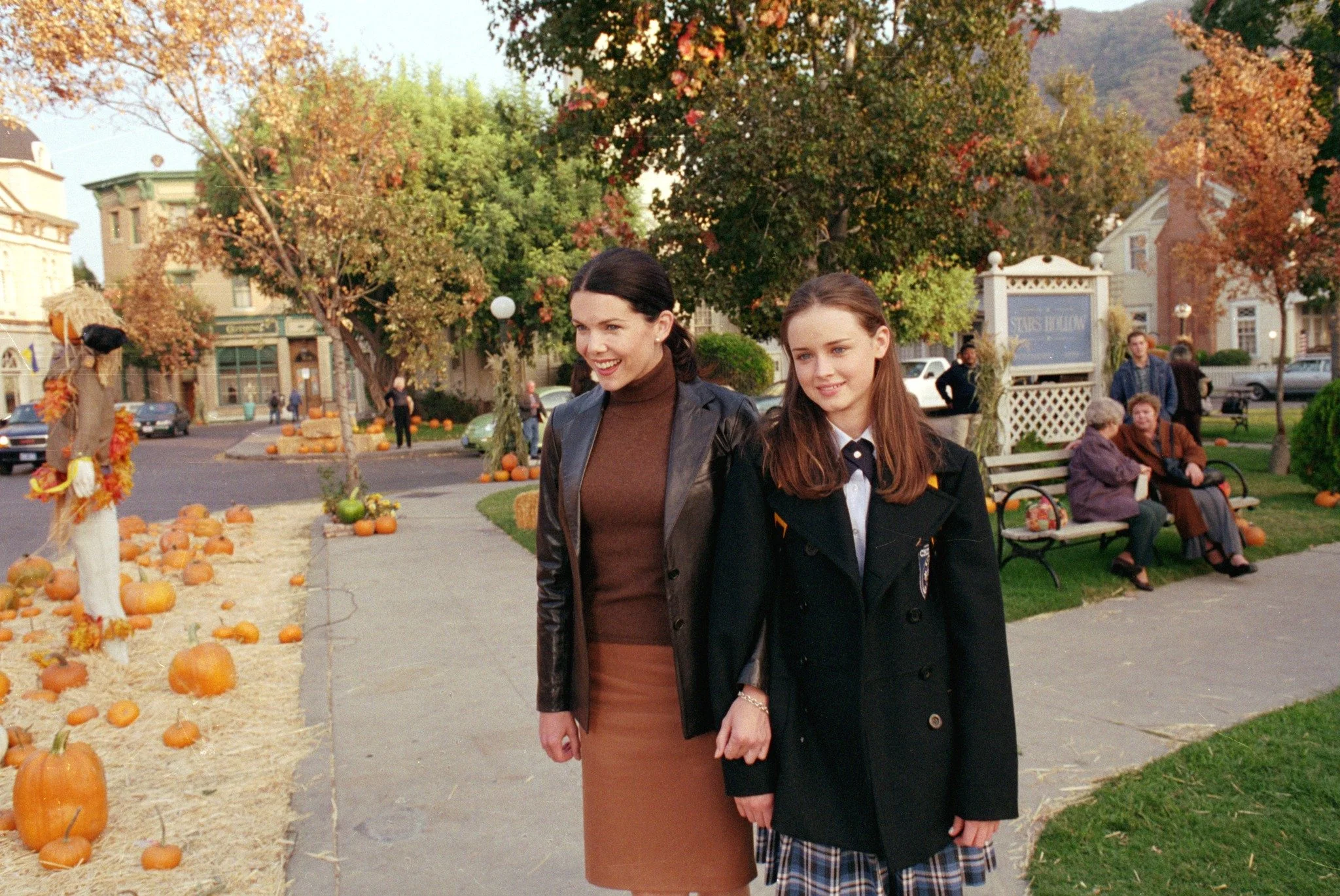 Lorelai and Rory Gilmore strolling through autumnal Stars Hollow