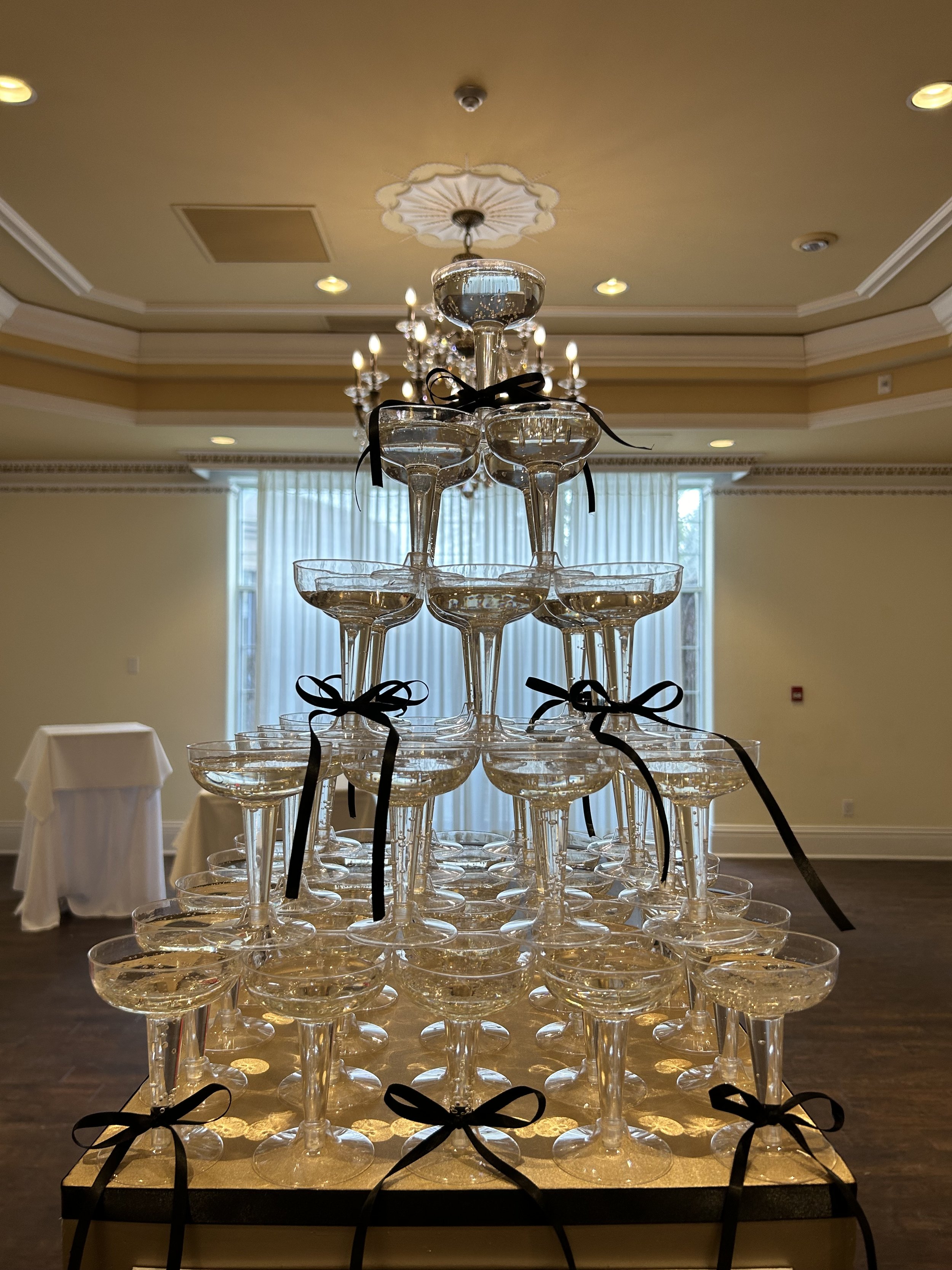 Champagne tower with black bows to add some glamour to your next party