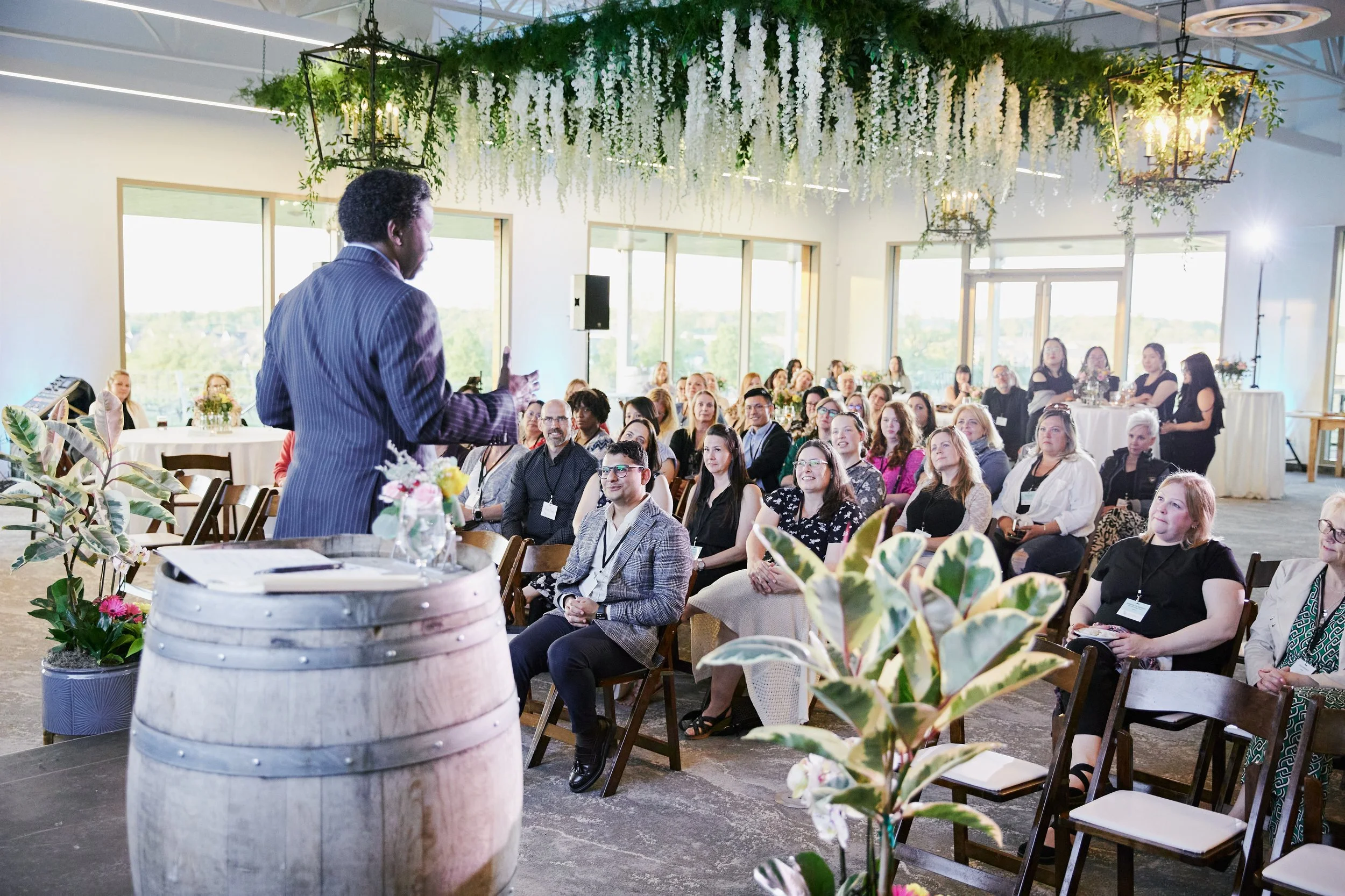 Speaker presenting in a room decorated by Fête Events
