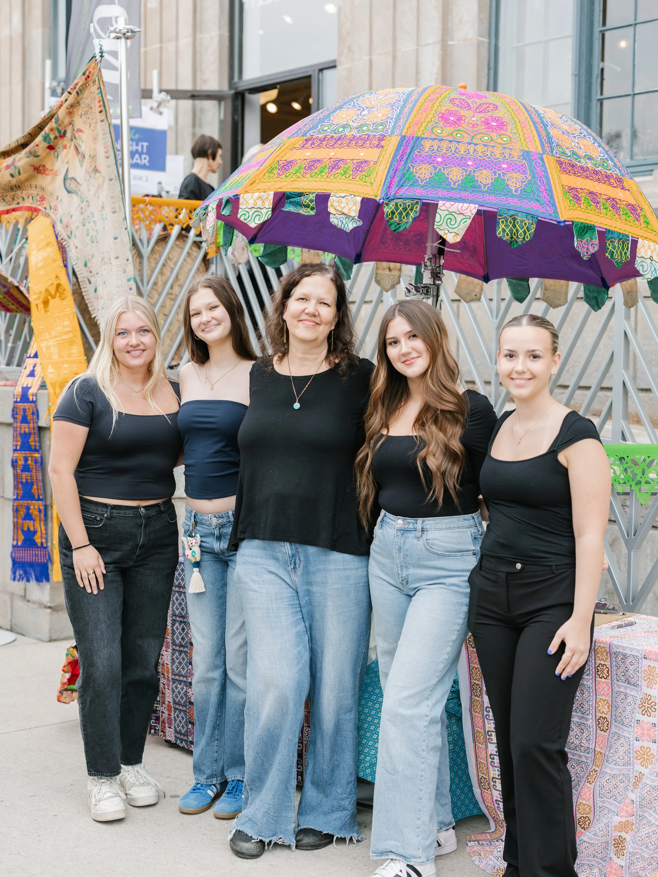 Group of women smiling at Shannon Passero's The Post Office for the Night Bazaar