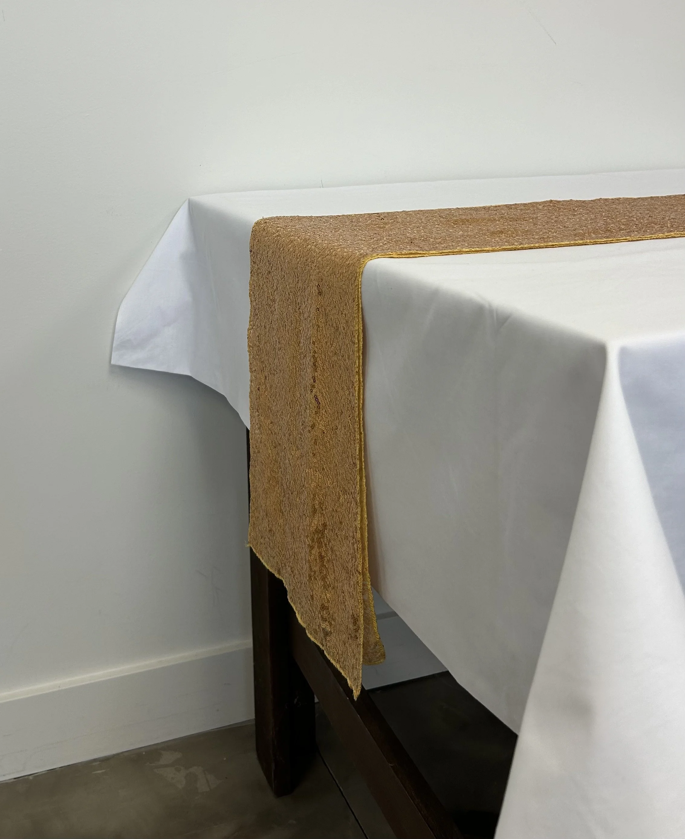 Add some glamour to your next party with this gold sequin table runner