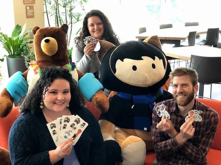 Salesforce Trailblazer Community holding out the much-loved Salesforce stickers Image via Salesforce Blog