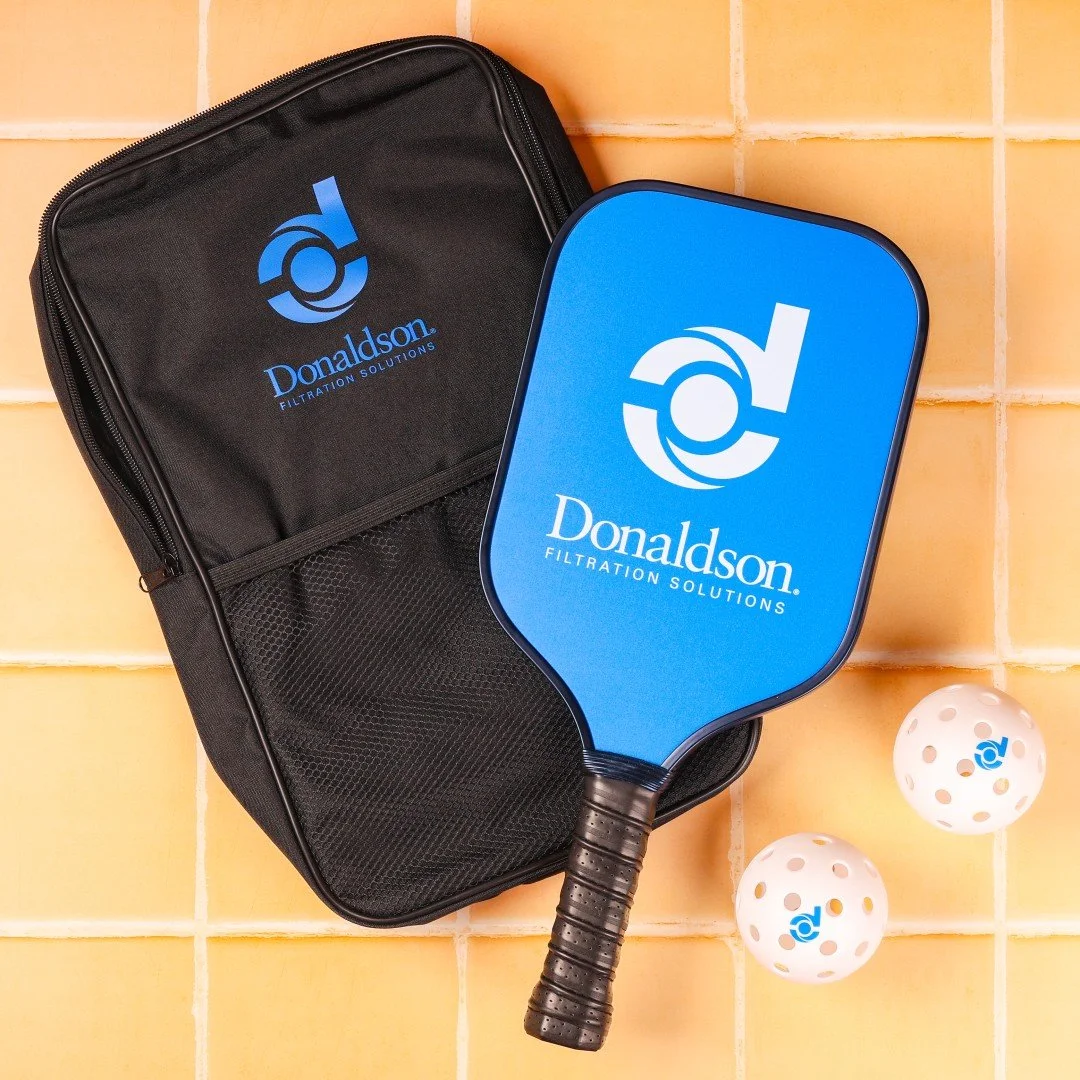 Game on, brand strong 🏓 Donaldson takes team spirit to the next level with this custom pickleball set — logo-printed paddles, bag, and balls that score big on style and brand recall. Ready to create your own branded game set? Let’s make
