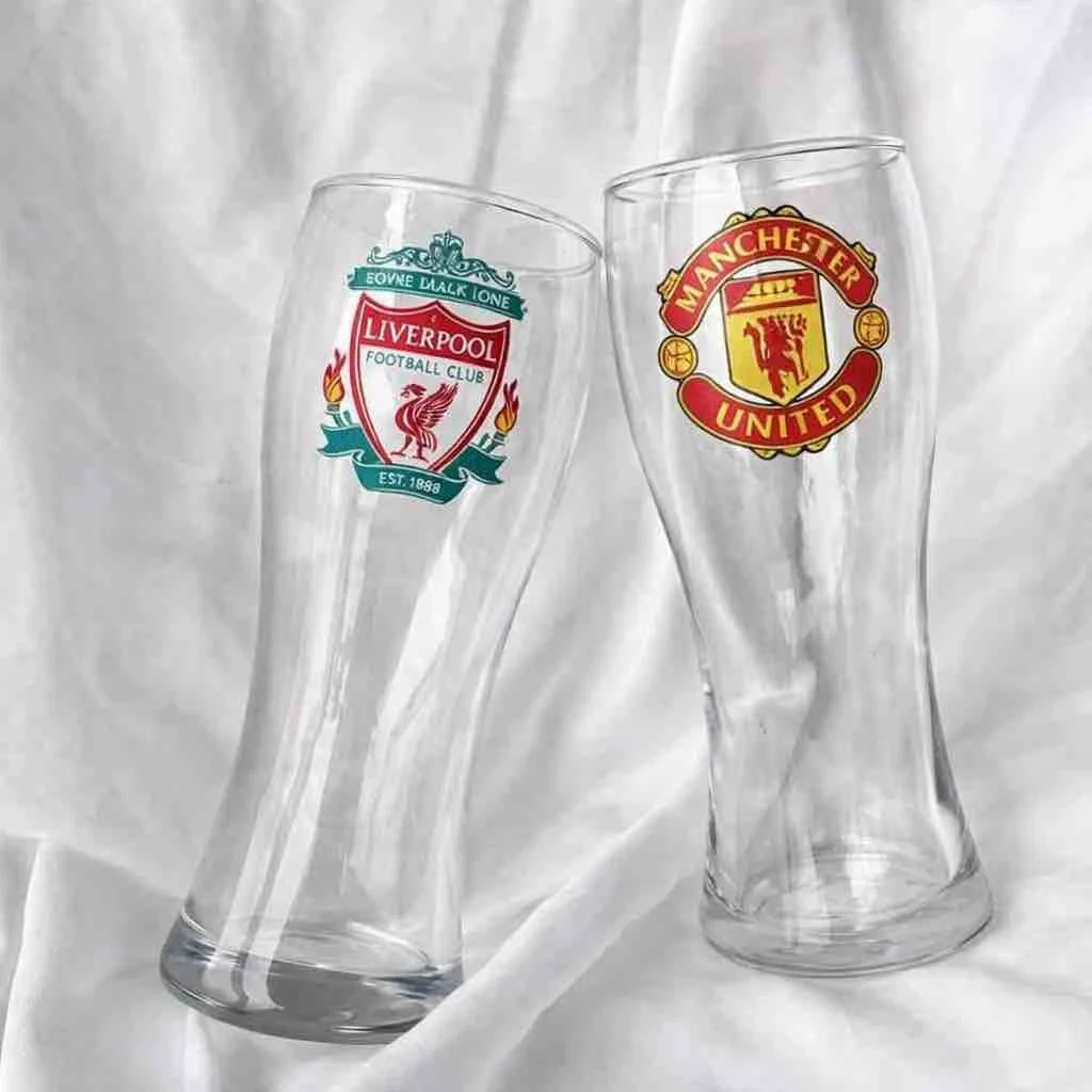2 Beer glasses with liverpool and manchester united branding on a white background