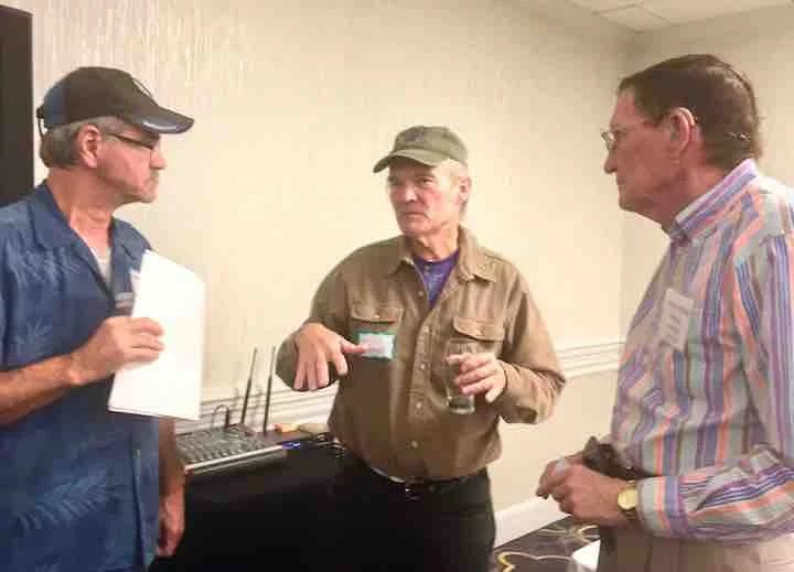 Glen Schneider (middle) talks to members.