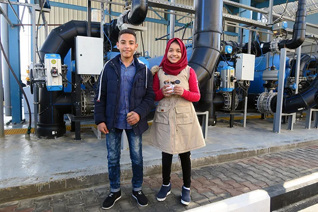 Thirteen-year-old Ahmad and 12-year-old Shahd stand in the new seawater desalination plant. Their class went on a tour of the plant as part of a UNICEF-supported C4D campaign to raise awareness about the safe water. Photo credit: UNICEF State of Palestine/2017/Weibel