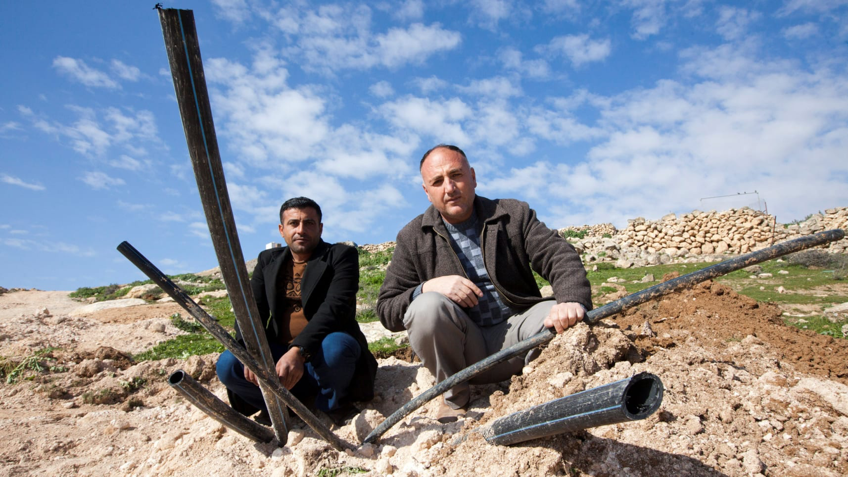 Younes (right) and al-Raba’i with what remains of the water pipes. February 17, 2019. Photo Credit: Eliyahu Hershkovitz