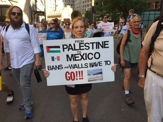 Susan, an Alliance and JVP member, at the "Never Again" protest on July 2. After walking from the New England Holocaust Memorial to the Suffolk Count House of Correction where many migrants are detained, about 1,000 activists stopped traffic in Boston. They chanted "Never Again" and "close the camps."
