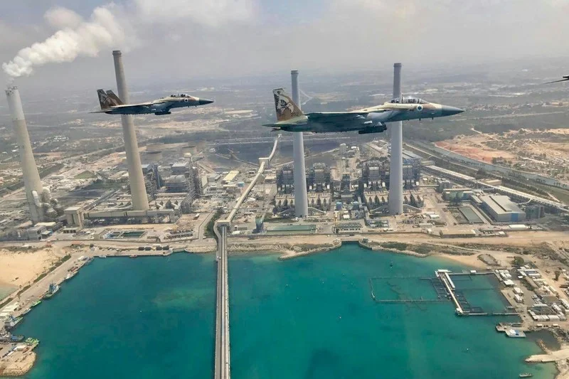 Israeli warplanes make a ceremonial flyby of the Israel Electric Corporation’s Orot Rabin coal-fired generating station, to mark what Israel calls its Independence Day, May 2017. The power company is deeply complicit in Israel’s violations of Palestinian rights. ( via Facebook )