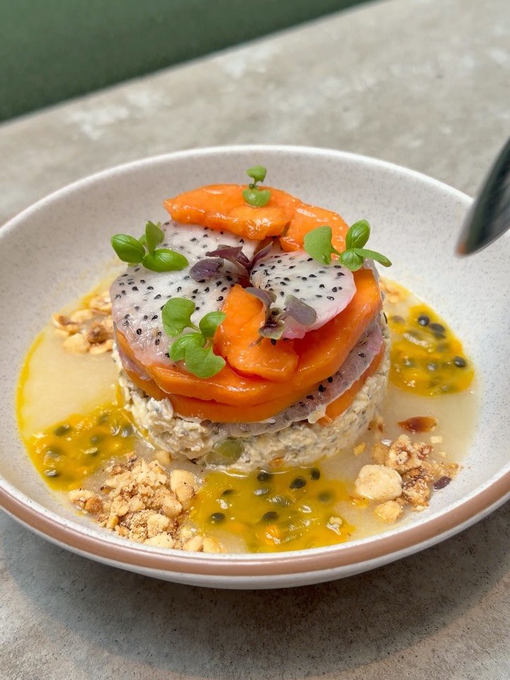 NEW 🌸 Light, bright, vegan! Coconut Bircher muesli now on the menu, with pear &amp; yuzu pur&eacute;e, dragonfruit, papaya, passion fruit and hazelnuts 🧡