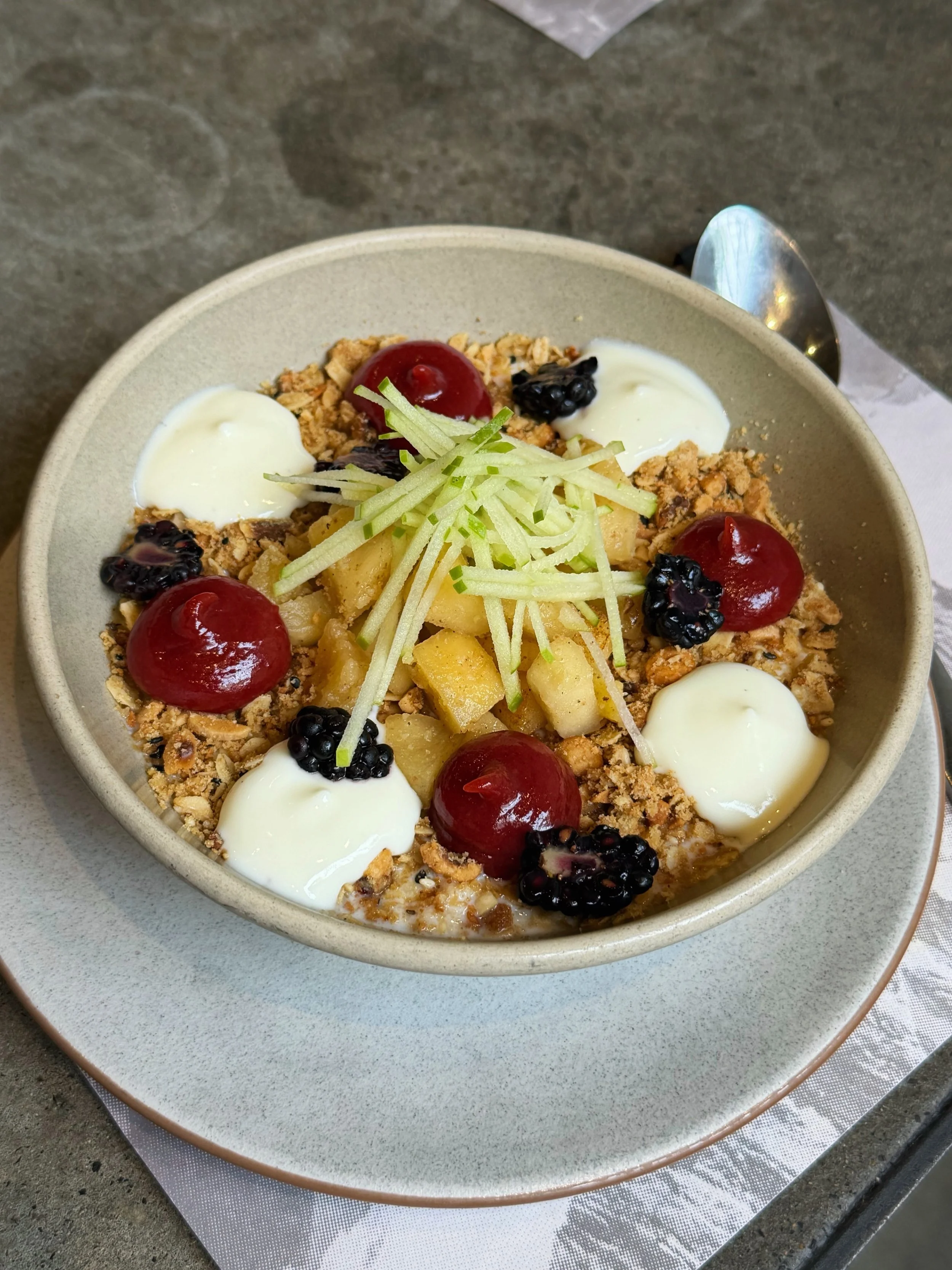 A Winter favourite ❄️ Sweet oat porridge with caramelised apple, blackberries, vanilla bean yoghurt, oat-nut crumble, Medjool date and rhubarb caramel.