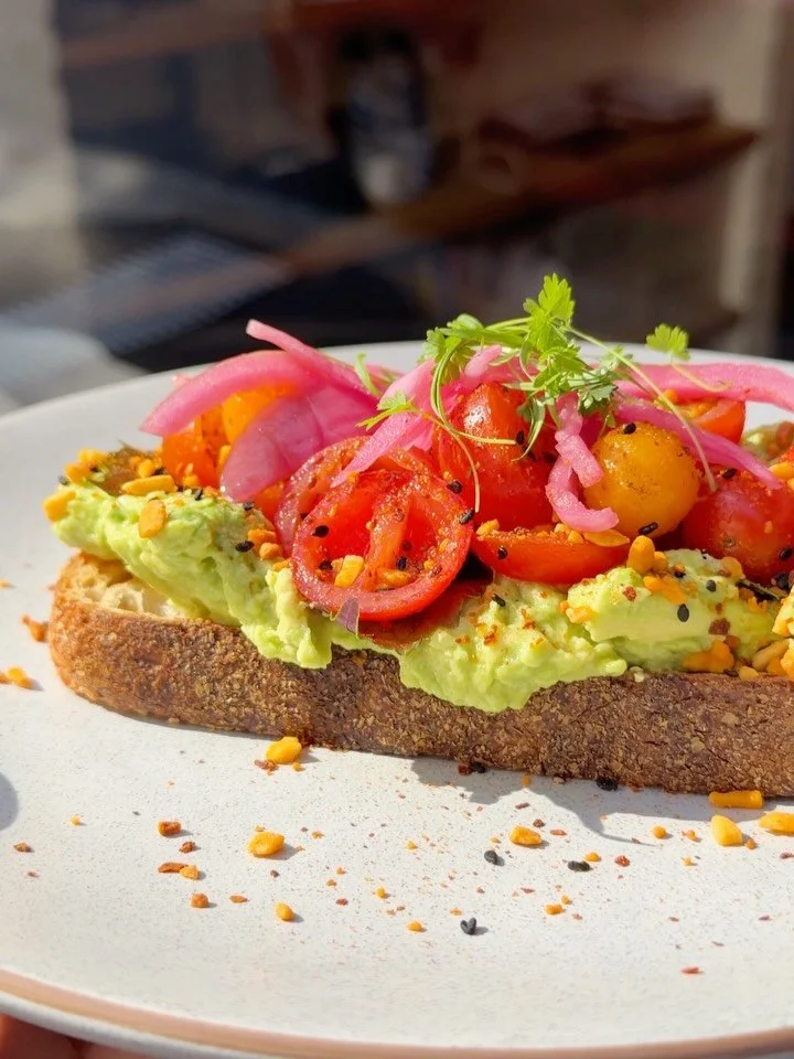 Avocado Toast, the PCP way ⚡️ Smashed on @a.p.bread with heirloom tomatoes, shiso leaves, pickled onion, raspberry vinaigrette, Aleppo pepper &amp; almond furikake.