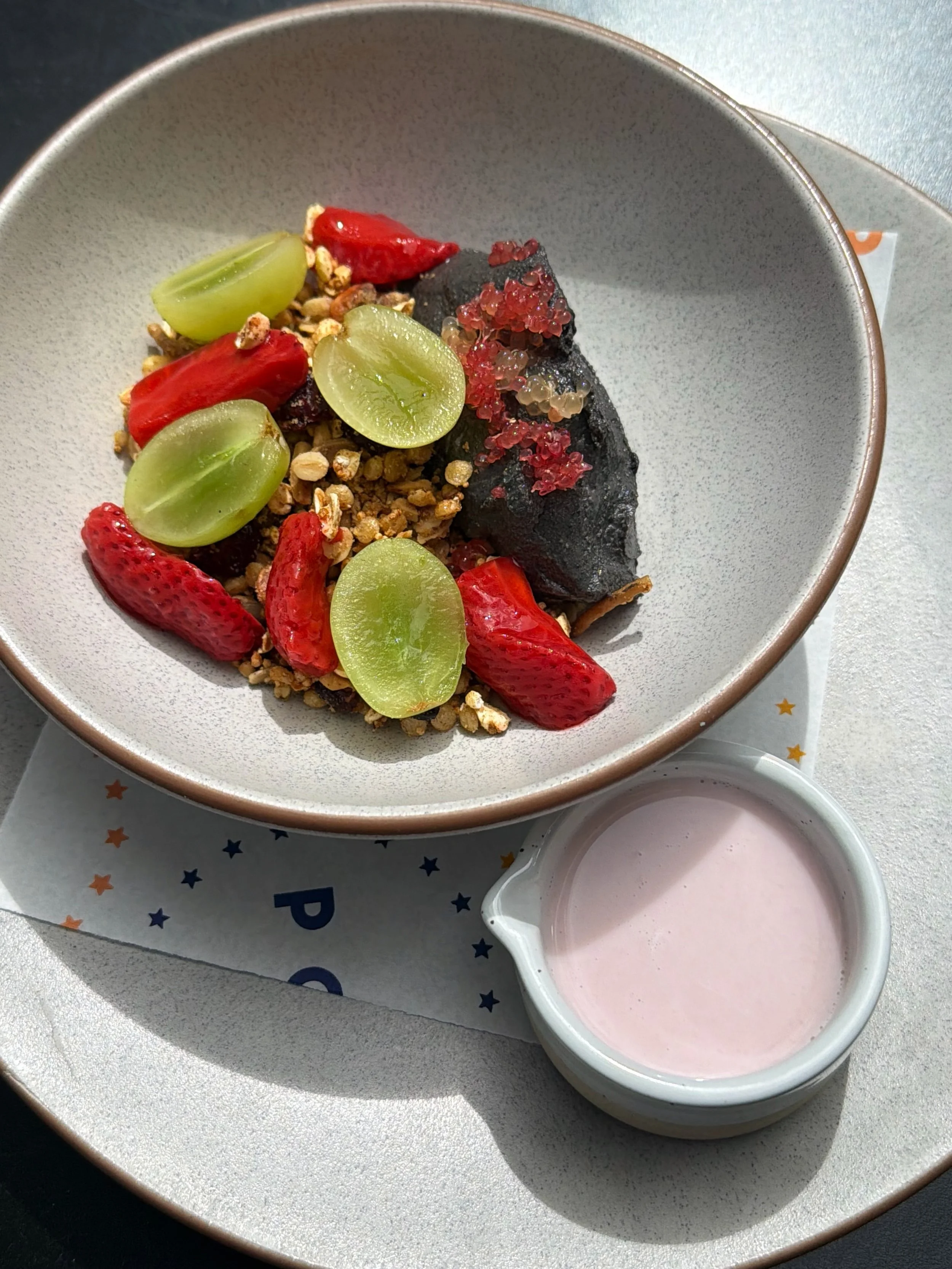 NEW! Black Sesame &amp; Buttermilk Panna Cotta with macadamia &amp; cranberry granola, poached strawberry, seasonal fruit and finger lime plus house strawberry milk. A bowlful of Spring 🌸