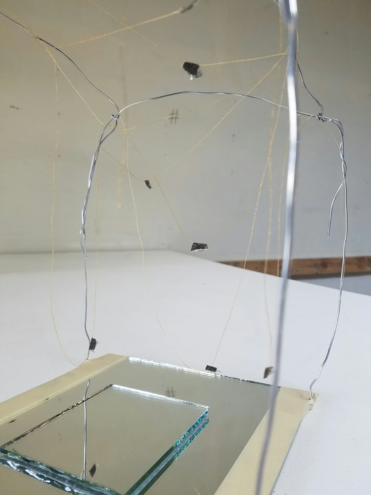 This group created the bed chamber as a cenotaph with the path of the fly a residue in the air. Small glimpses can be made of the fly and its path is rendered with gold thread. The mirrors reflect the ceiling - the view of the dying speaker - thus ensuring the viewer shares her perspective. 