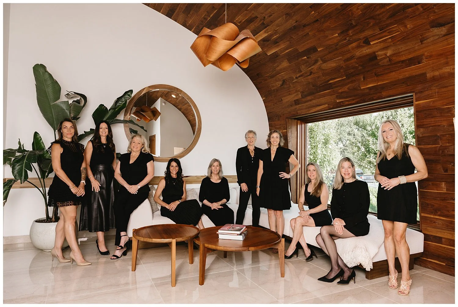 Group portrait of eleven Briggs Freeman Sotheby's International Realty women agents in a Total Environment home at Tapestry in Frisco, Texas