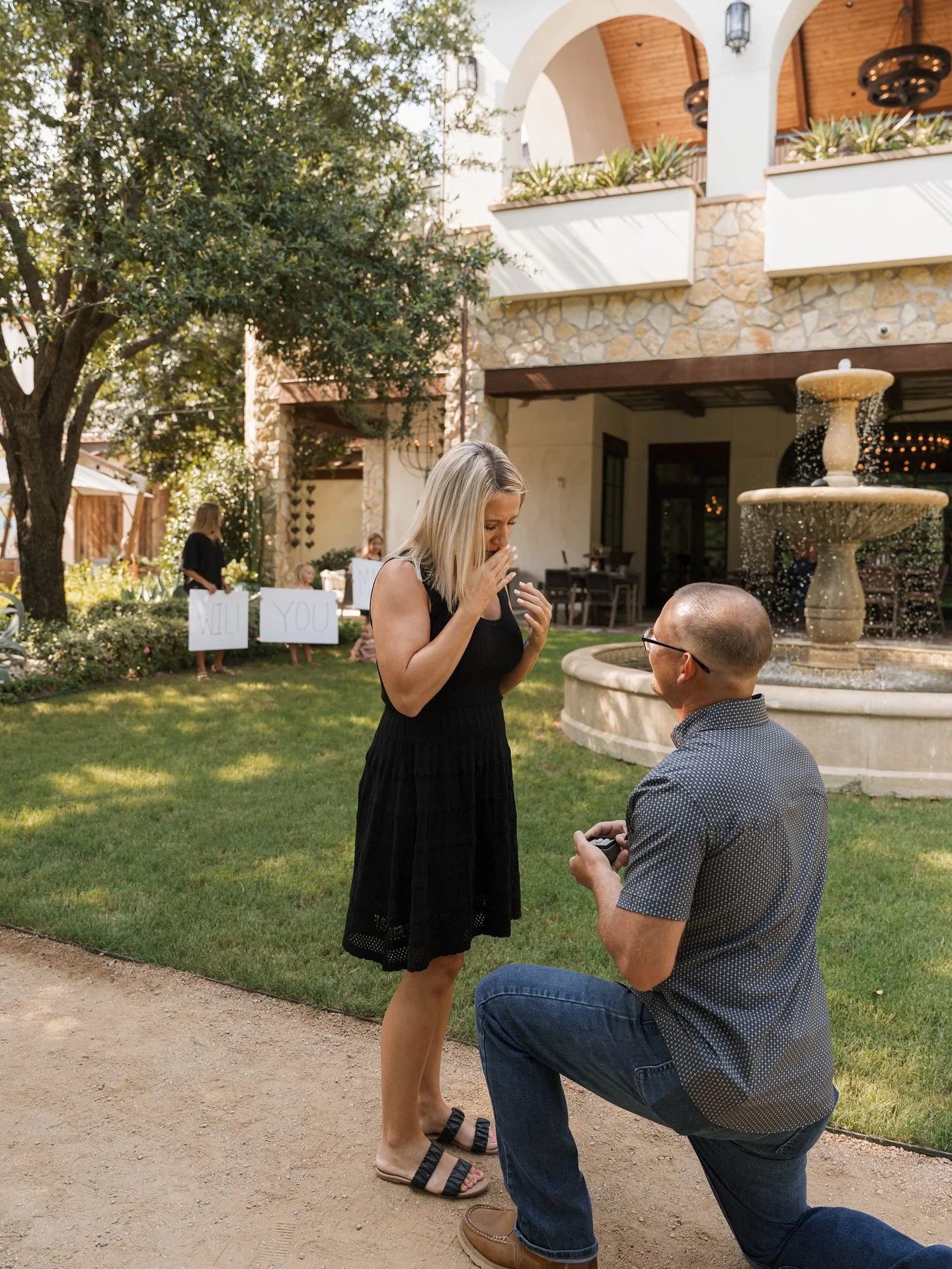 She said YES 💍

This surprise proposal was absolutely perfect! Located at Hotel Drover in Ft. Worth in their back garden next to a fountain shipped in from Spain!  How cute are their five children holding signs 🥹

Swipe to view the celebrations 🤍?