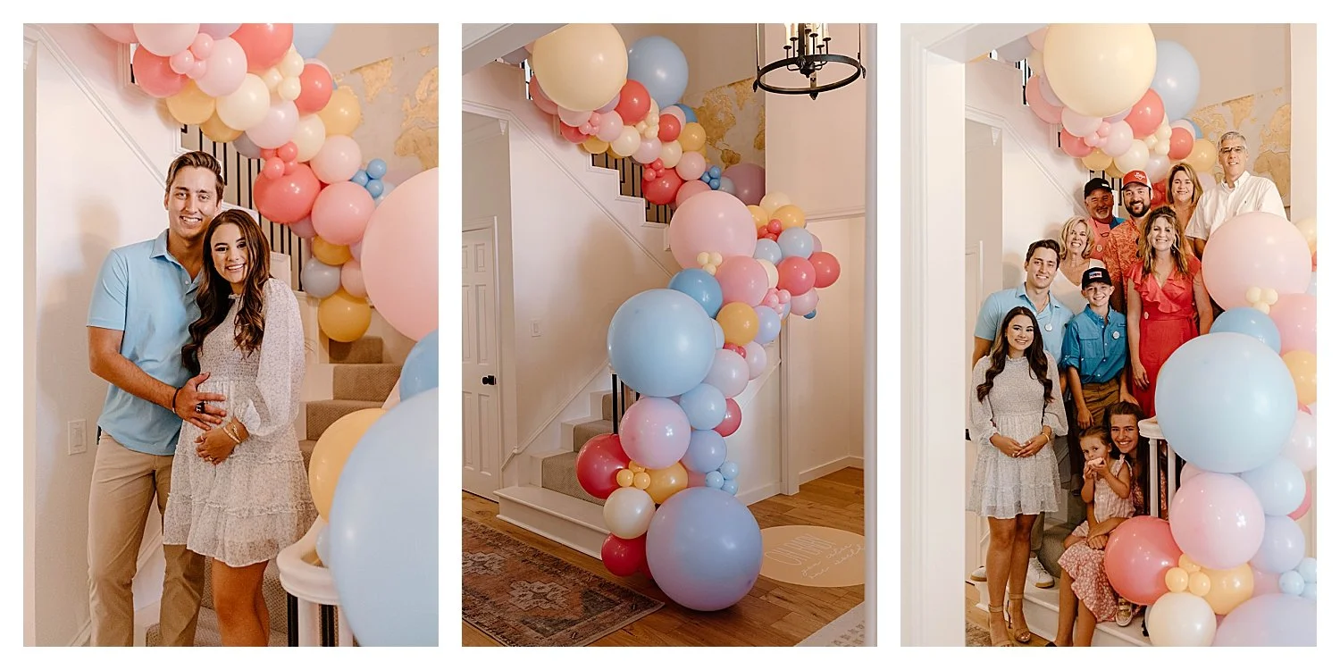 Expecting couple and family on the staircase with a pastel balloon garland at a Dallas baby shower