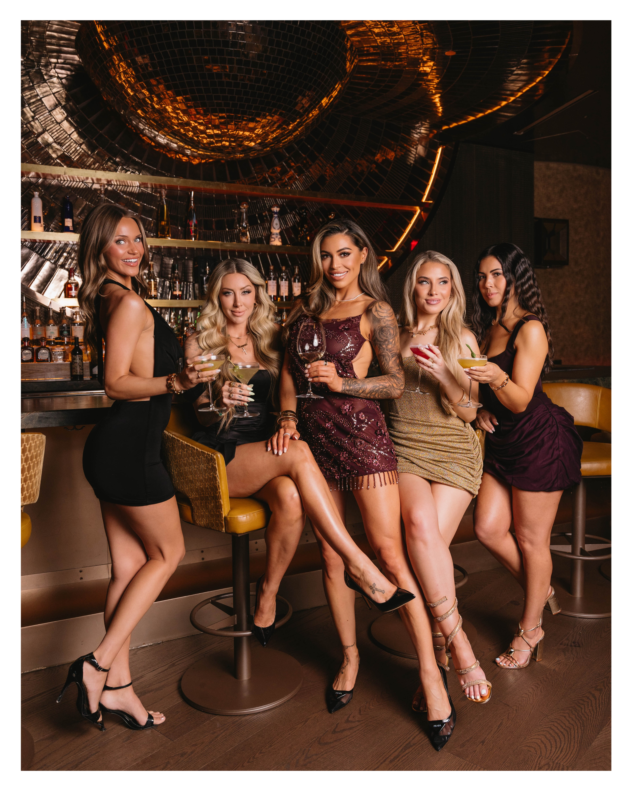 Girls night out group photo at the bar under the disco ball ceiling at EVELYN in the Dallas Design District