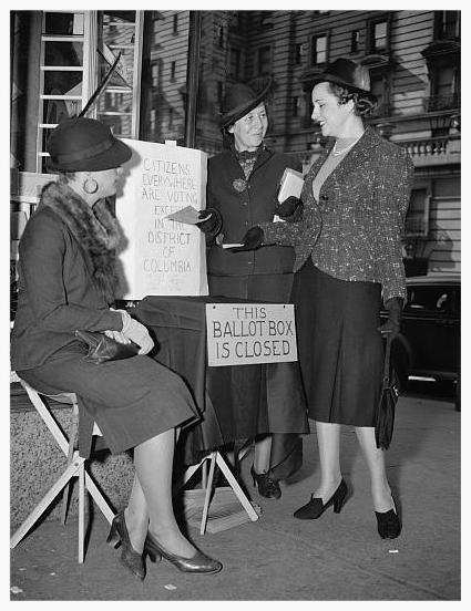 1936 - DC League volunteers set up a closed ballot box to protest the lack of voting in the District of Columbia. (Library of Congress)