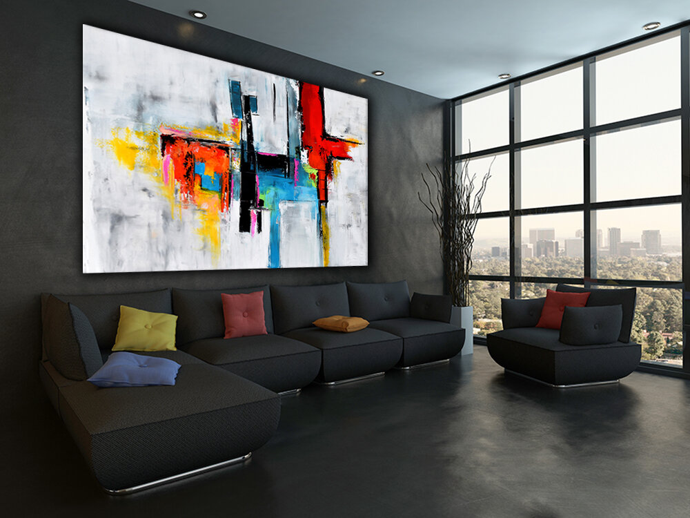 Black couch with colorful pillows against wooden wall