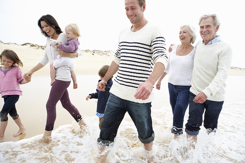 Multi-Generation-Family-Walking-Along-Beach-Together-000021765403_Full.jpg