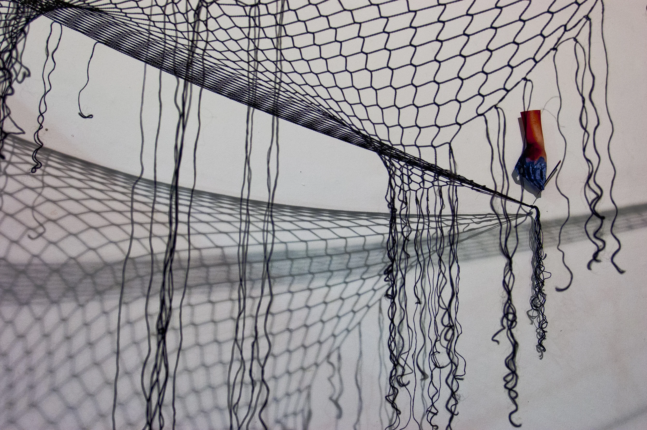 parlor games: axioms (detail showing netting made of hair extensions)