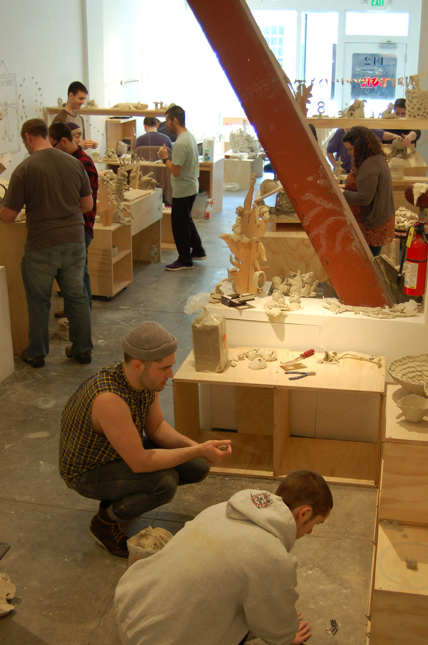 open for construction participants adding more clay pieces to the installation