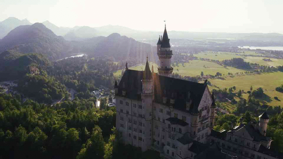 aerial-shot-of-neuschwanstein-castle-in-fussen-bavaria-germany-during-beautiful-sun-SBV-338294167-HD(1).gif