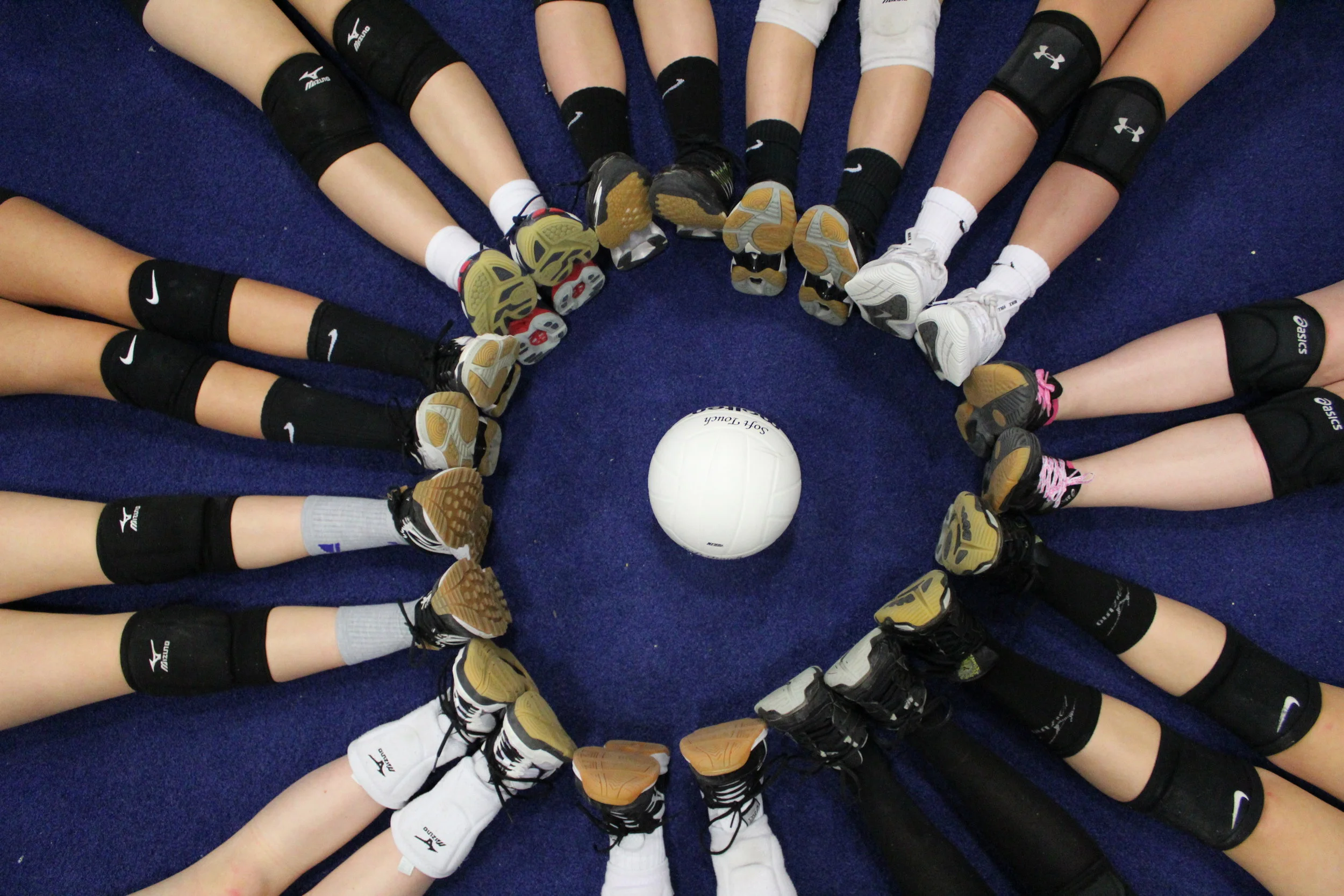 14 Blue shoes surround a volleyball.jpeg