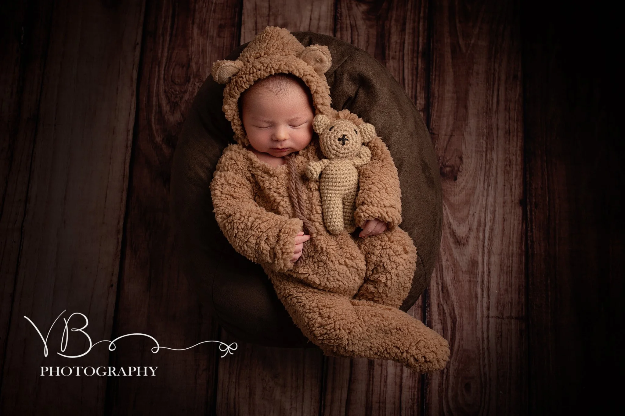 Image of Newborn Baby in warm tones dressed as a cuddly bear